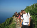 Walking through the vineyards, facing the blue expanse of the sea